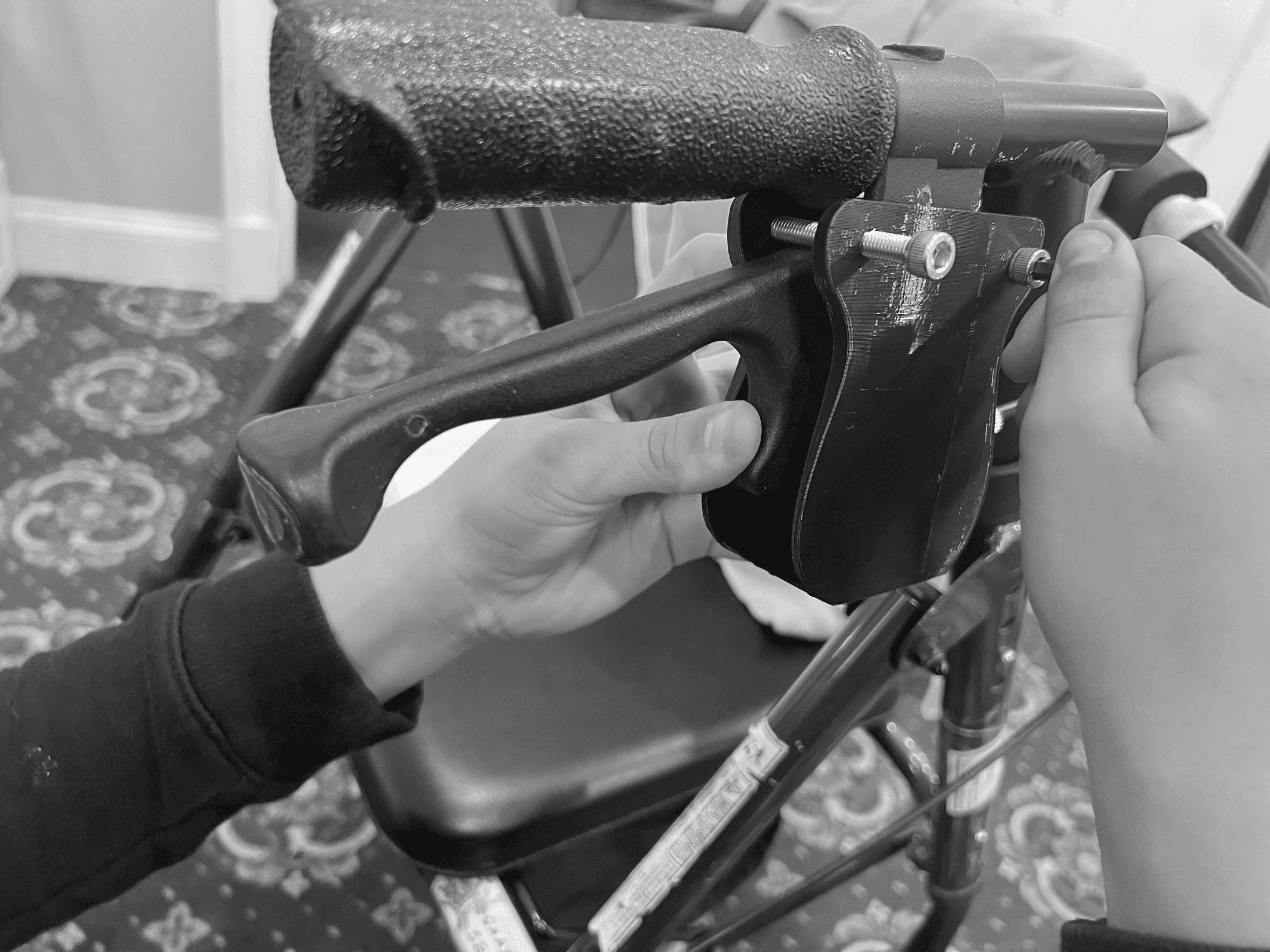 Hands repairing the brake assembly on a mobility device